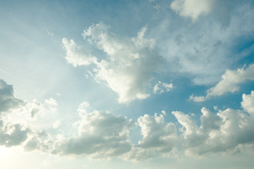 Sunlight and burst explode in cloudy blue sky clouds background