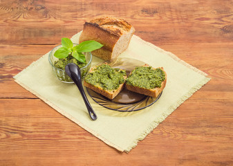 Sandwiches with pesto, sauce pesto and bread on a napkin