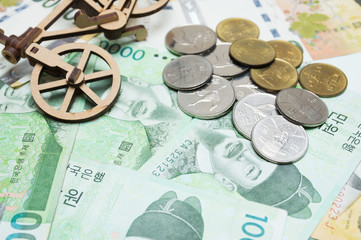 Toy bicycle and coin on South Korean won currency