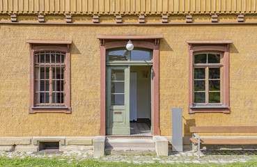 Fototapeta na wymiar historic house facade with entrance and windows