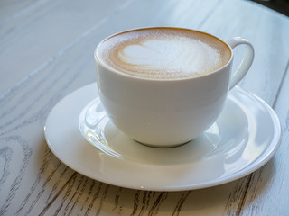 Latte in white cup as breakfast
