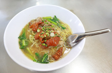 Roasted Duck nooddle in the bowl with chopsticks and spoon.
