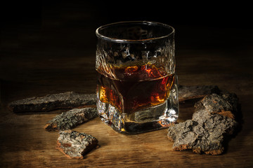 Whisky in the glass on wooden table. Brutal vintage concept