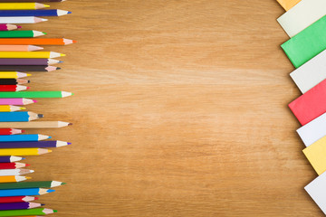 Obraz premium Color pencils on the wooden table. Art concept. Top view. Empty place for a text or drawing on the background.