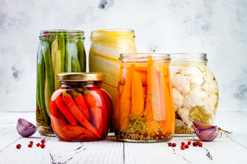 Marinated pickles variety preserving jars. Homemade green beans, squash, cauliflower, carrots, red...
