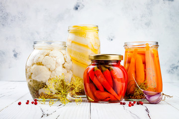 Marinated pickles variety preserving jars. Homemade cauliflower, squash, carrots, red chili peppers...