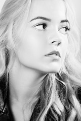 Fototapeta premium beautiful young blond female portrait on white background, monochrome
