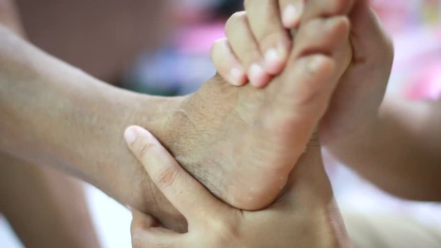 Hands of young woman gently touch massage to foot of old women metaphor and concept for body health care and therapy  of family old mother and young daughter
