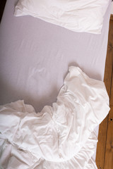Fototapeta na wymiar Bed closeup, white quilt bedding and pillow