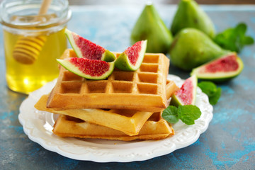 Homemade waffles with caramel sauce, figs and raspberries.