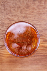 Beer on wooden background. Glass of beer or ale, view from above, top studio shot, overhead