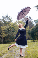 Beautiful girl with umbrella at autumn park