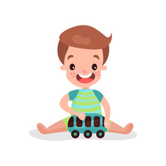 Sweet little boy sitting on the floor playing with toy car cartoon vector Illustration