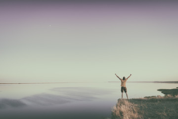 Obraz na płótnie Canvas Man standing on a edge of precipice. Instagram stylization