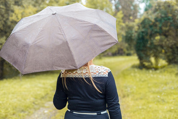 Beautiful girl with umbrella at autumn park