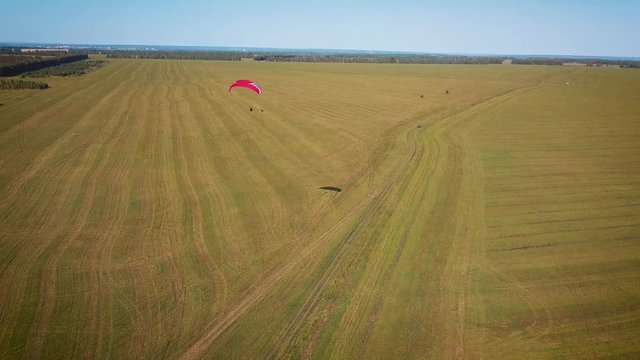 Paraplane, paraglider in the air aerial shot. Extreme life. A man is flying on a paraglider