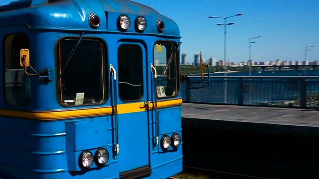 A subway train passes a station underground