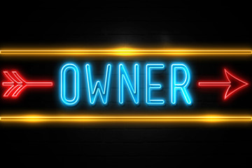 Owner  - fluorescent Neon Sign on brickwall Front view