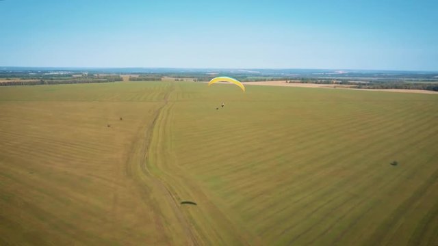 Paraplane, paraglider in the air aerial shot. Extreme life. A man is flying on a paraglider