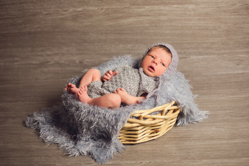 a newborn baby boy in a basket
