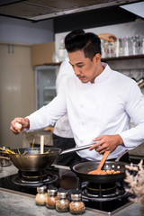 Chef preparing food in the kitchen of a restaurant 