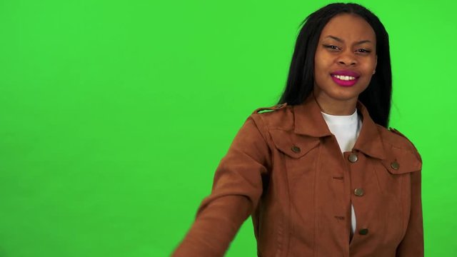 A young black woman is angry and shakes her head at the camera - green screen