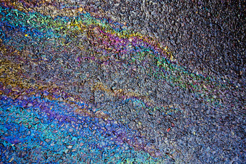 Metallic Rainbow Petrol Spill on Pavement Sidewalk