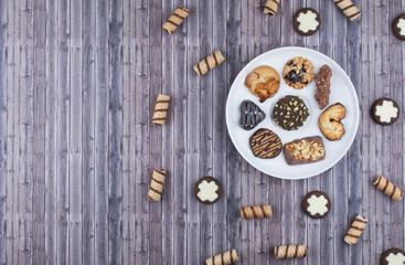 Fototapeta na wymiar Dark vintage background with various homemade cookies.