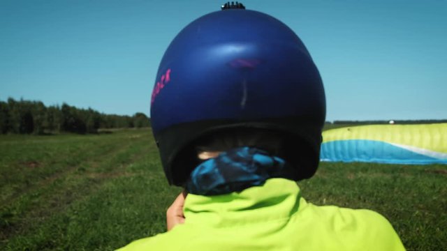 Girl and protactive helmet. blonde girl wearing helmet for head protection. Will fly on a paraglider