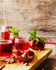 Fresh pomegranates and juice, selective focus
