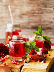Fresh pomegranates and juice, selective focus