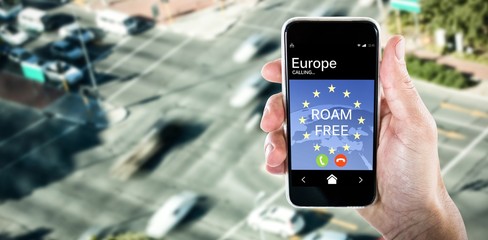 Composite image of close-up of cropped hand holding phone