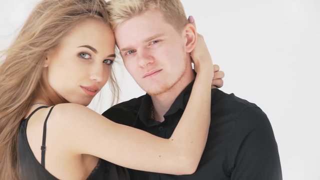 loving couple man and woman, on a white background in black clothes.