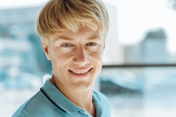 Portrait of joyful handsome light haired man