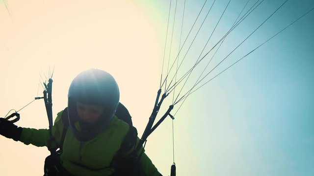 Paragliding girl. Paraglider is ready to take off over a green hill