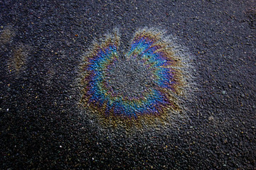 Metallic Rainbow Petrol Spill on Pavement Sidewalk