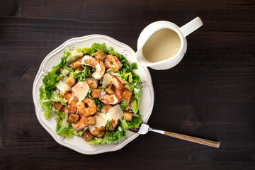 Overhead photo of shrimp Caesar salad with copyspace