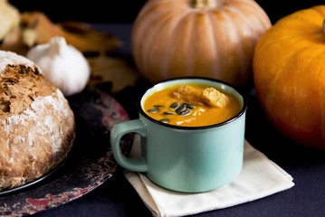 Pumpkin soup in a mug with home made bread