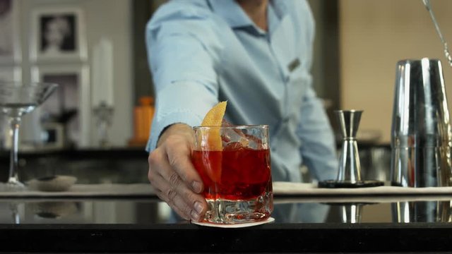 Barman preparing a cocktail in luxury bar interior. close-up