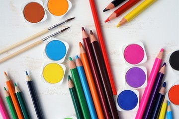 Color pencils and watercolor background copy space