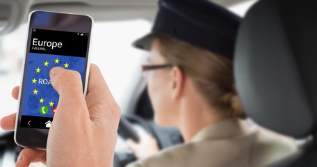 Composite image of cropped hand of man using mobile phone