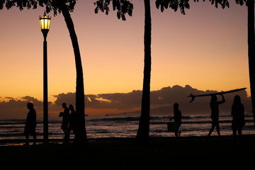 Fototapeta na wymiar People on the sunset beach