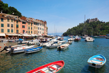 Fototapeta na wymiar Portofino typical village with colorful houses and small harbor with boats in Italy, Liguria