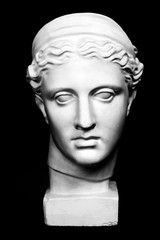 Marble head of young woman, ancient Greek goddess bust isolated on pink background