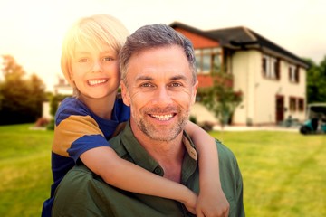 Composite image of father holding his son on his back