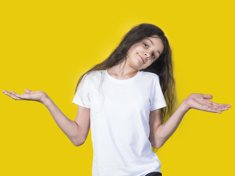 Young beautiful girl making surprise gesture on colorful background