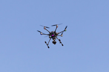 Flying drone with blue sky background