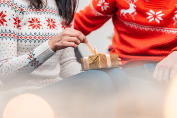 couple wrapping christmas present