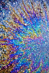 Fototapeta premium Metallic Rainbow Petrol Spill on Pavement Sidewalk