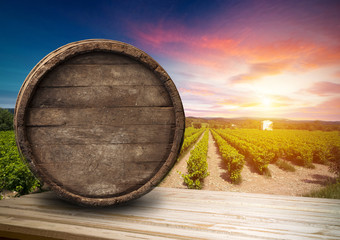 Red wine with barrel on vineyard in green Tuscany, Italy